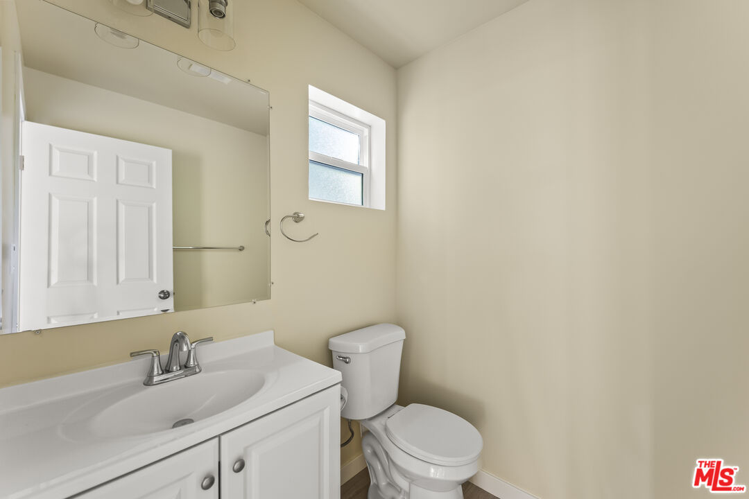 5741 Simpson Avenue Valley Village, CA 91601 - Photo 11 of 11 a bathroom with a toilet a sink and mirror