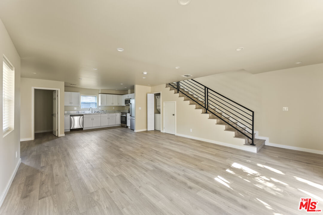 5741 Simpson Avenue Valley Village, CA 91601 - Photo 3 of 11 a view of a livingroom with wooden floor and stairs
