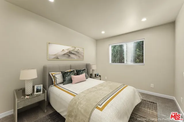 a bedroom with a bed and a lamp on table