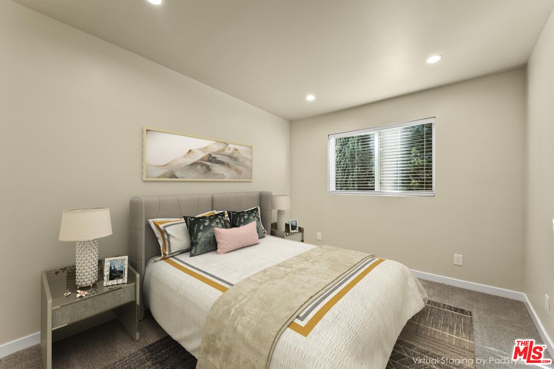 5741 Simpson Avenue Valley Village, CA 91601 - Photo 5 of 11 a bedroom with a bed and a lamp on table