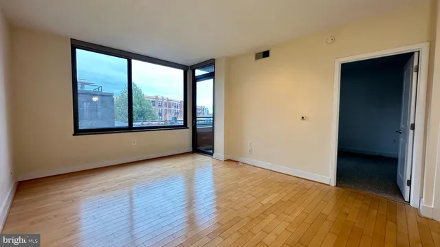 a view of a livingroom and a kitchen with wooden floor