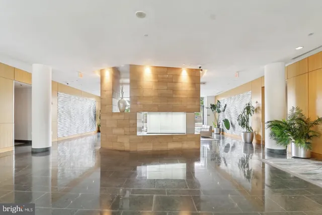 a lobby with furniture and floor to ceiling window