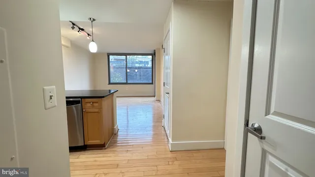 a kitchen with granite countertop a stove and a wooden floors