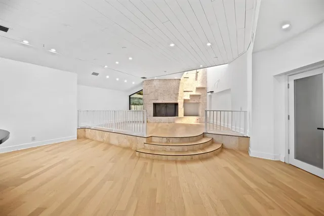 a large room with a fireplace and chandelier