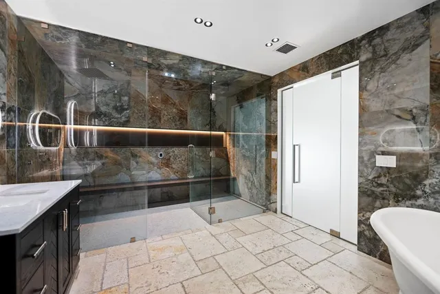 a bathroom with a bathtub and a shower