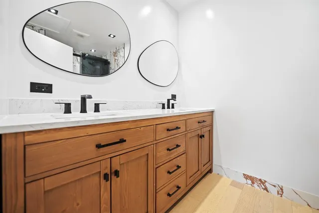 a bathroom with a sink mirror and vanity