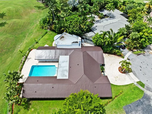 an aerial view of a house with garden space and street view