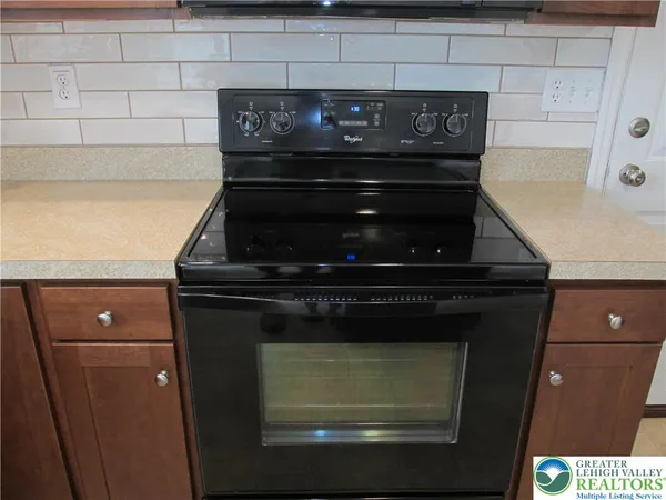 a stove top oven sitting inside of a kitchen