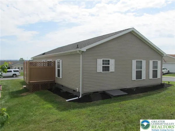 a view of backyard with a garden and deck