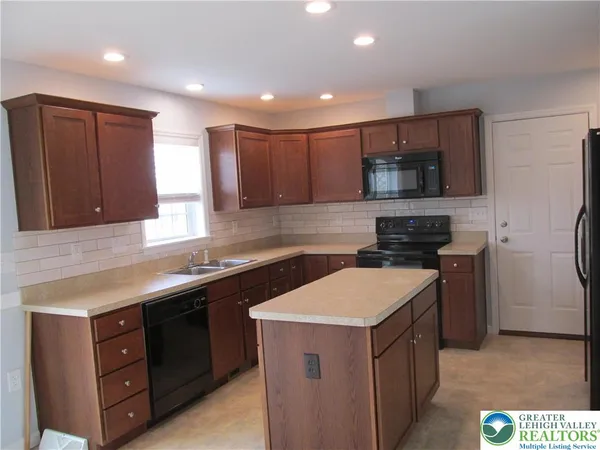 a kitchen with a sink a stove and refrigerator