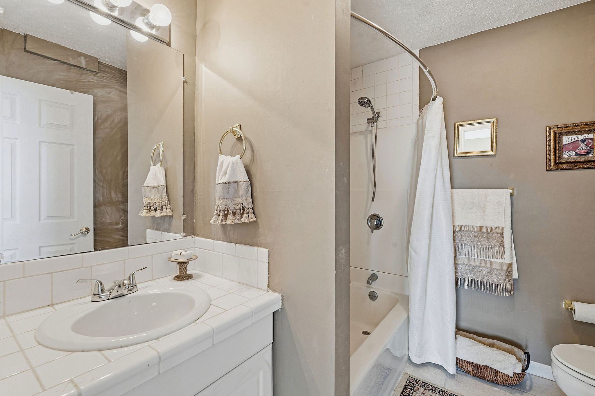 3230 West Fitzhugh Road Dripping Springs, TX 78620 - Photo 18 of 34 Functional bathroom featuring a tiled vanity and a combination tub and shower for everyday convenience.