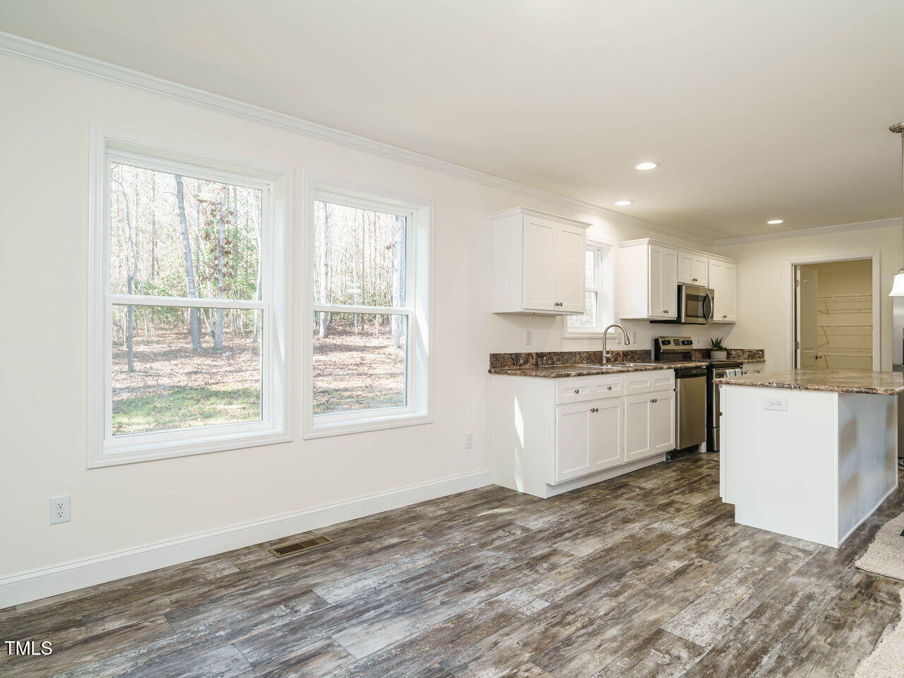 3050 Bennett Siler City Road Bennett, NC 27208 - Photo 12 of 40 a kitchen with granite countertop a stove top oven sink and cabinets