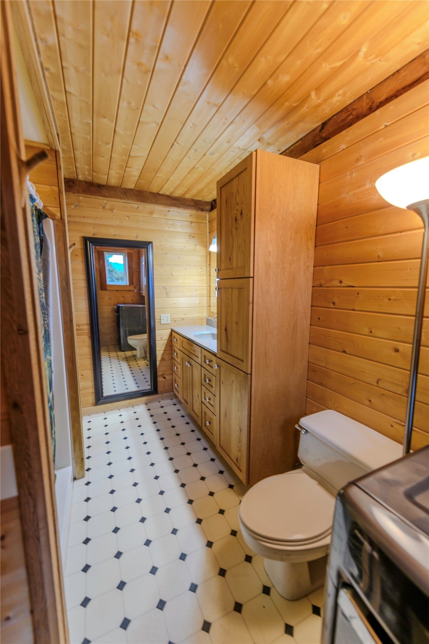 210 Friendspring Road Whitehall, MT 59759 - Photo 31 of 43 Bathroom featuring wooden walls, wooden ceiling, vanity, light flooring, and a shower with shower curtain