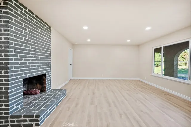 a view of kitchen with granite countertop cabinets and refrigerator