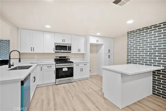 a kitchen with a sink a stove and refrigerator