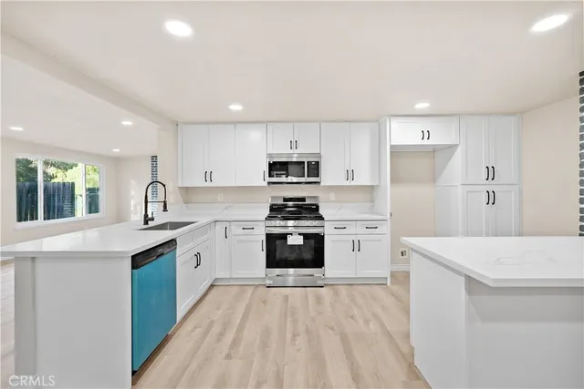 a view of a kitchen with a sink and a fireplace