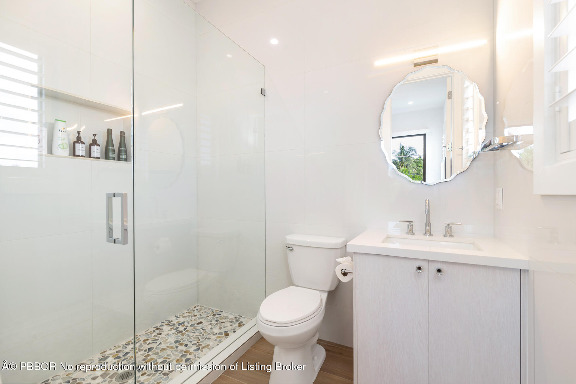 183 Arlington Road West Palm Beach, FL 33405 - Photo 22 of 34 a bathroom with a toilet sink and mirror