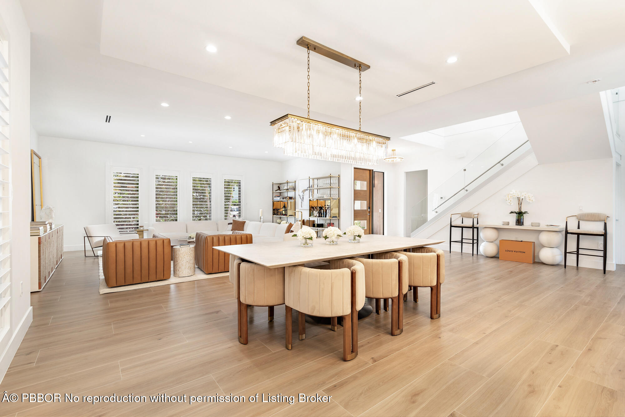 183 Arlington Road West Palm Beach, FL 33405 - Photo 6 of 34 a dining room with wooden floor a chandelier a glass table and chairs