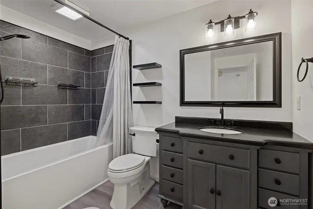 a bathroom with a toilet a sink and bathtub