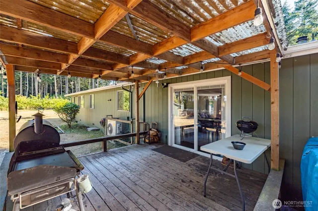 a view of a porch with furniture and a yard