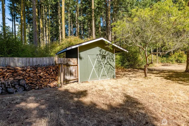a view of a yard with wooden fence