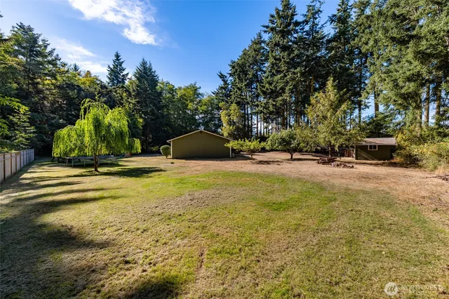 a view of yard with swimming pool and trees