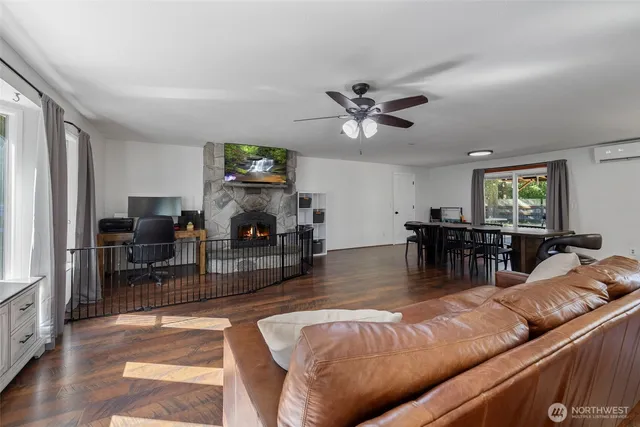 a living room with furniture a fireplace and a flat screen tv