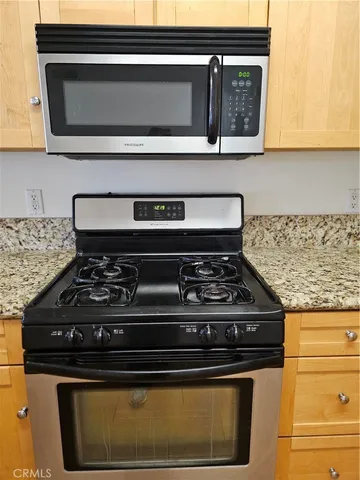 a stove top oven sitting inside of a kitchen