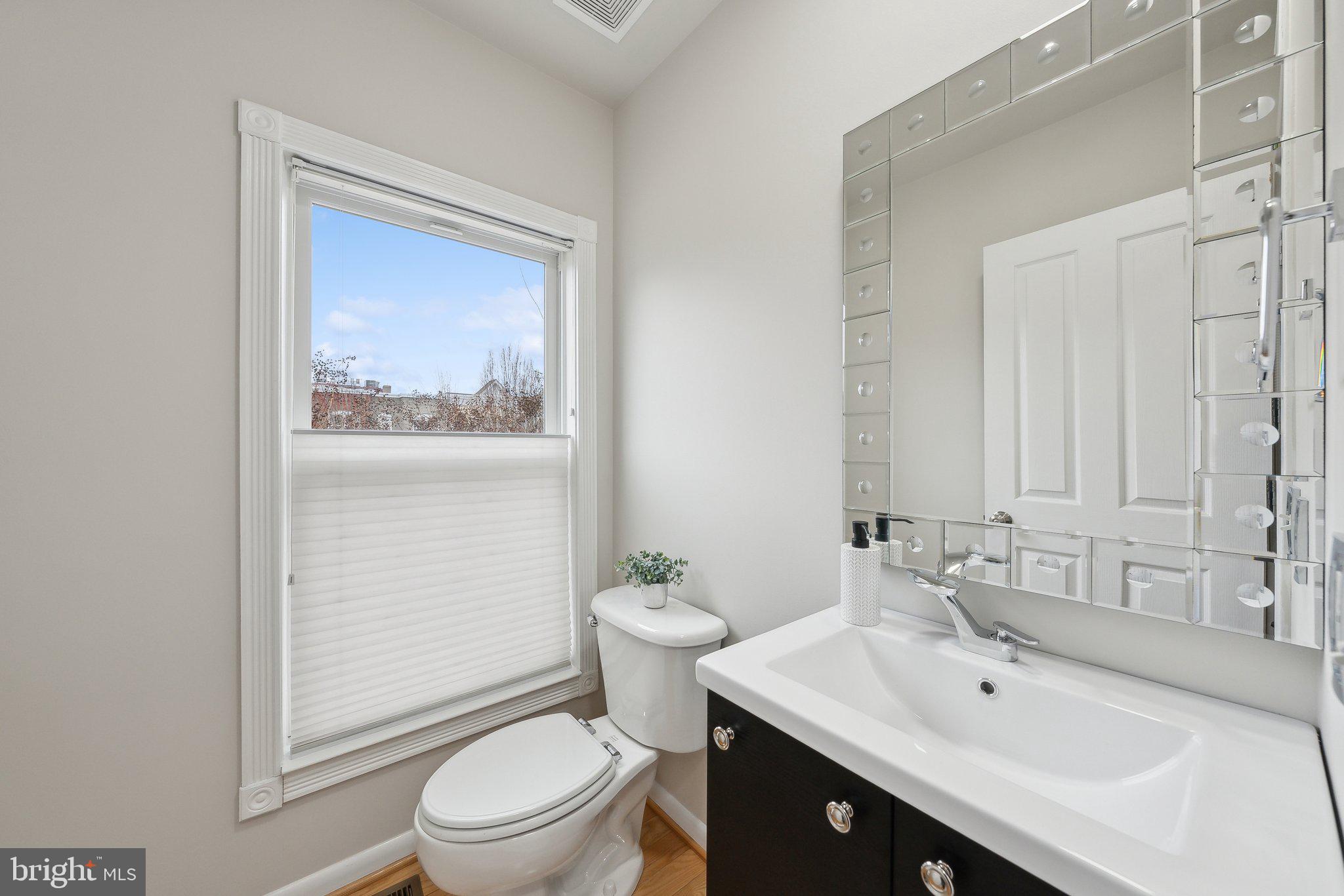 2136 12th Place Northwest Washington, DC 20009 - Photo 12 of 32 a bathroom with a sink a toilet and shower