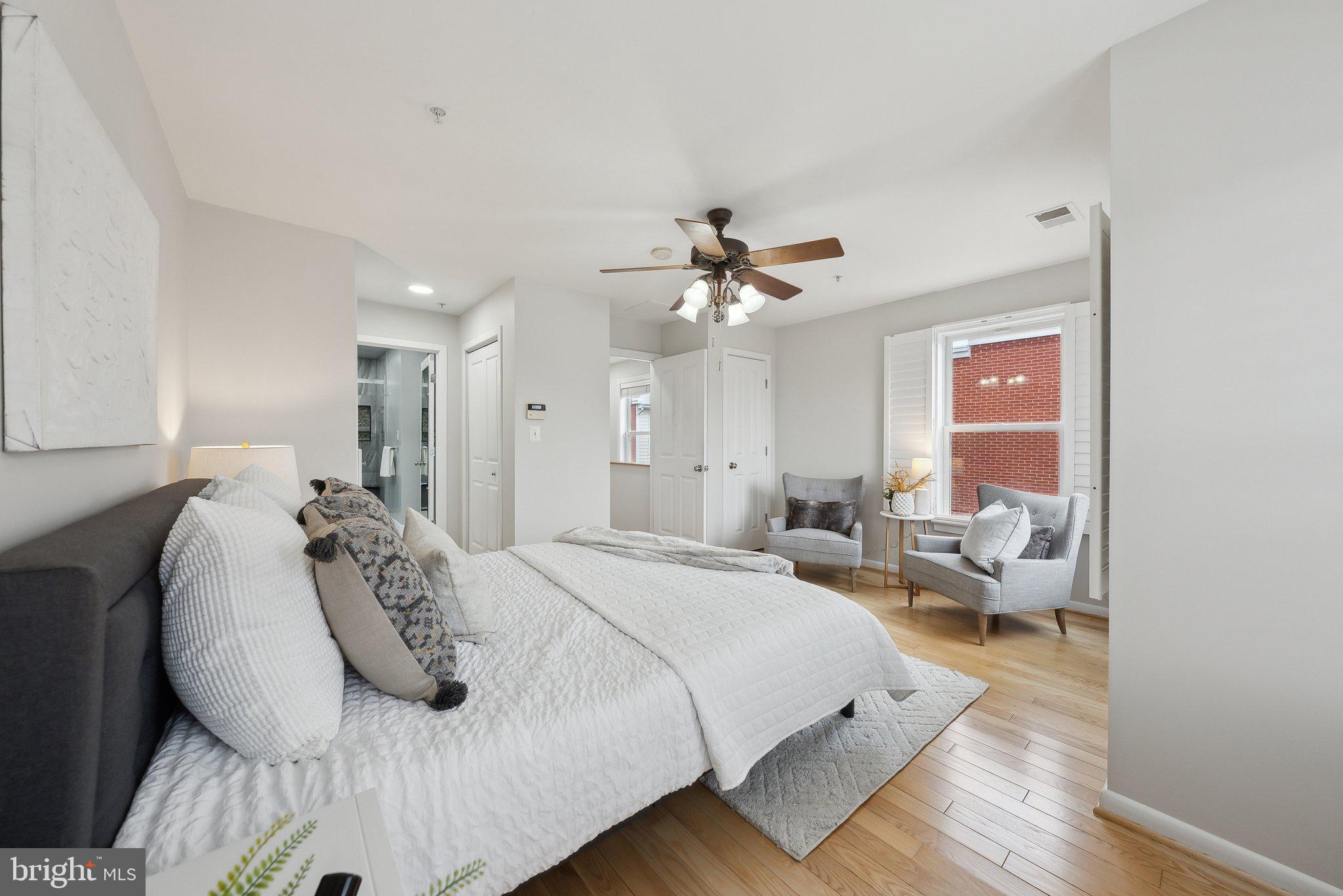 2136 12th Place Northwest Washington, DC 20009 - Photo 15 of 32 a spacious bedroom with a bed and a chandelier