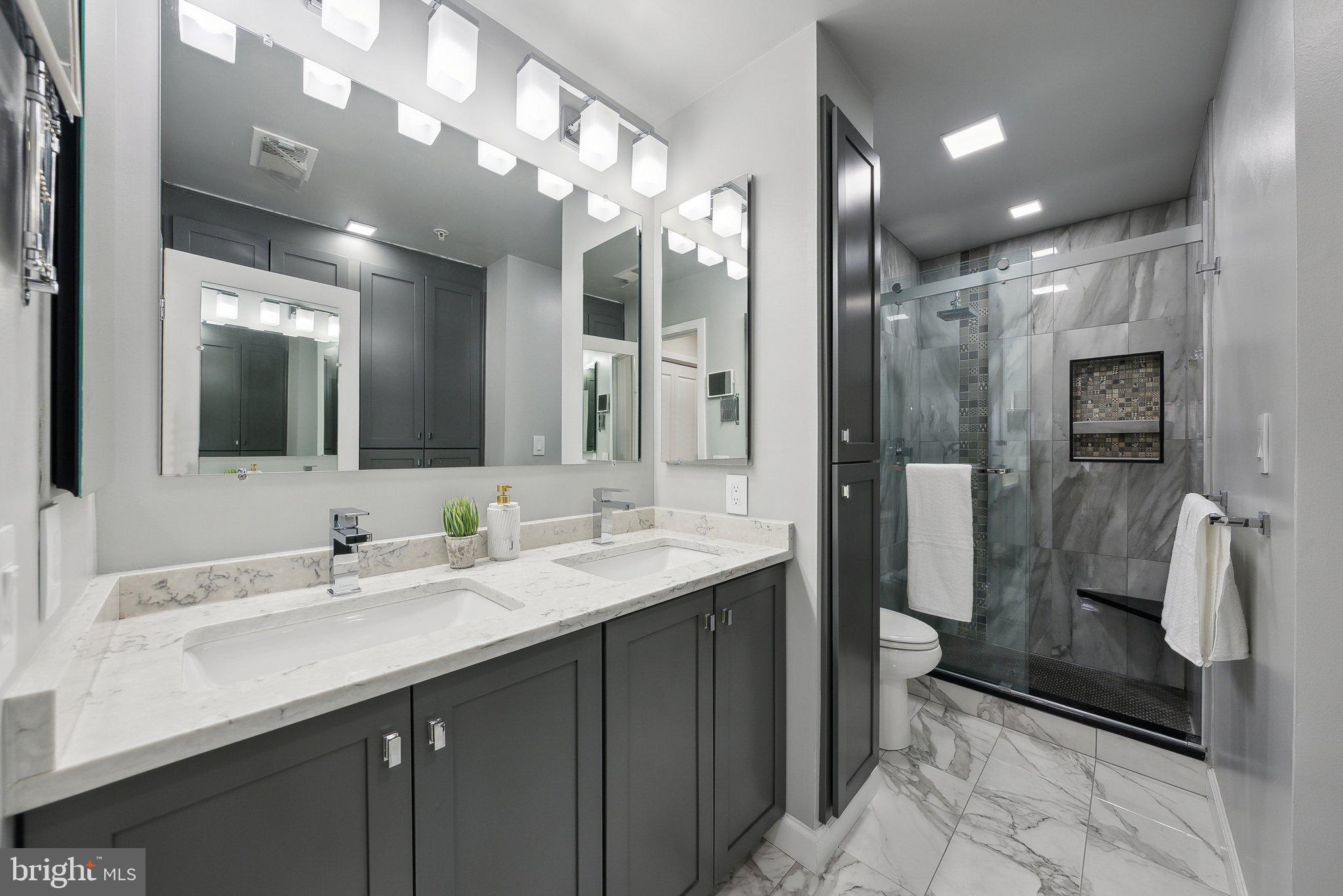 2136 12th Place Northwest Washington, DC 20009 - Photo 16 of 32 a bathroom with a double vanity sink a toilet and shower