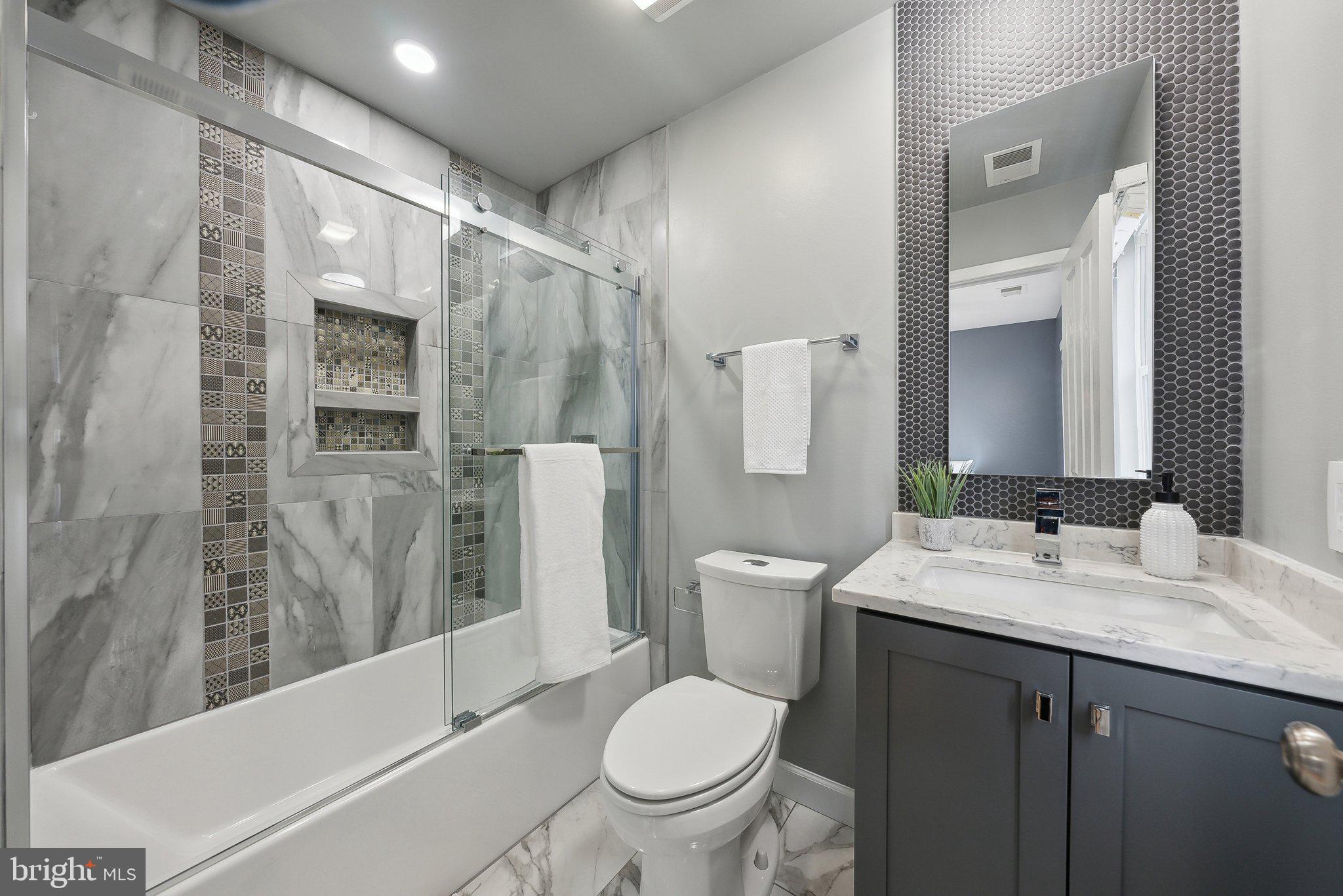 2136 12th Place Northwest Washington, DC 20009 - Photo 18 of 32 a bathroom with a granite countertop sink toilet and shower