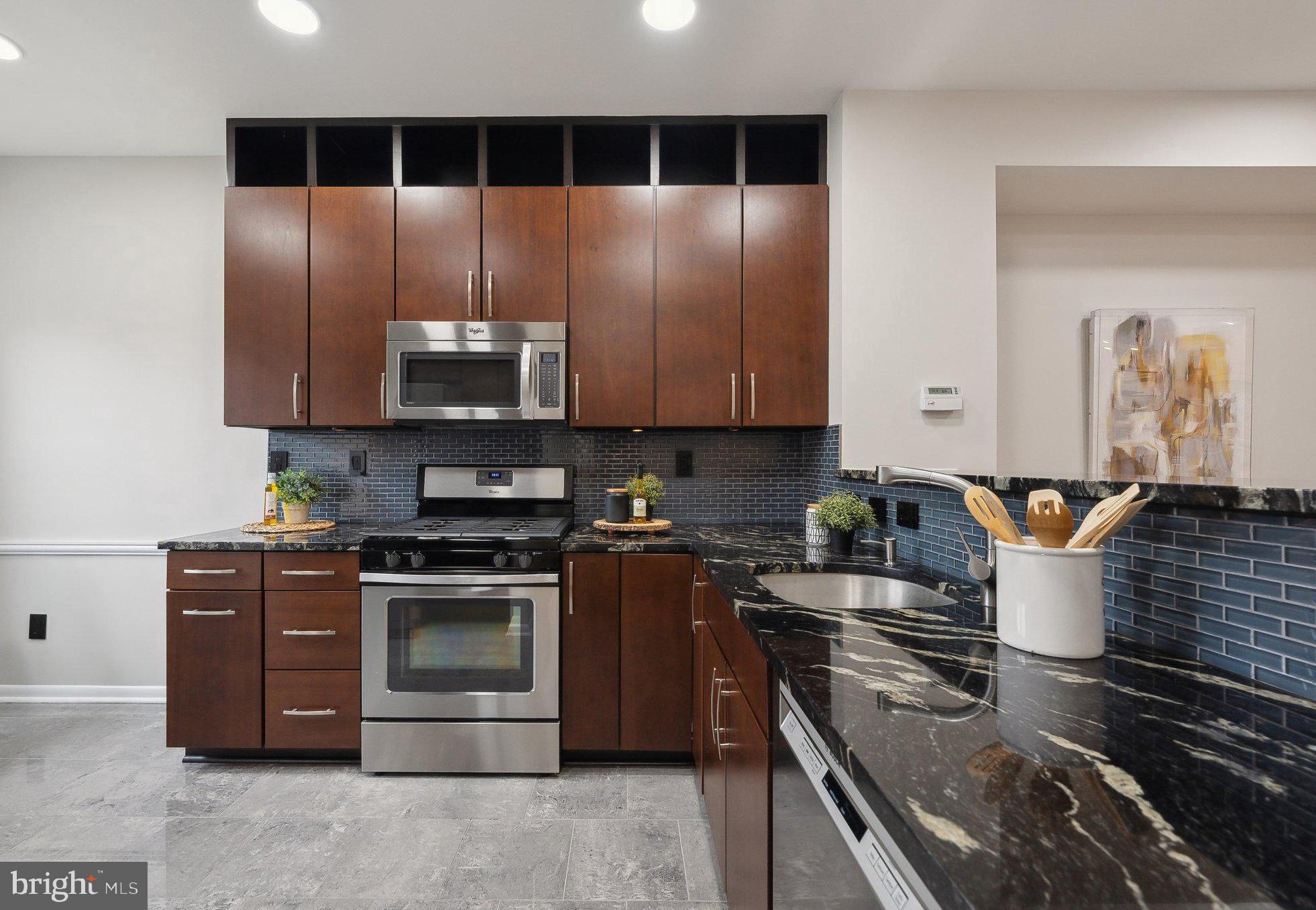2136 12th Place Northwest Washington, DC 20009 - Photo 8 of 32 a kitchen with stainless steel appliances granite countertop a stove a sink and a microwave