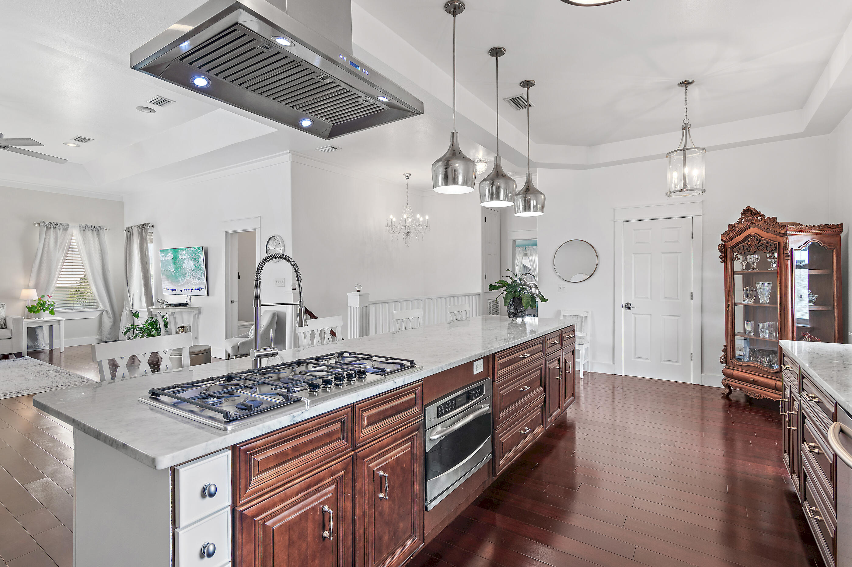 96 Hilltop Drive Santa Rosa Beach, FL 32459 - Photo 13 of 50 a kitchen with stainless steel appliances granite countertop a stove a sink dishwasher a dining table and chairs with wooden floor