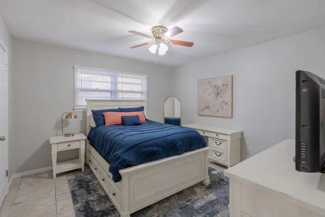 a bedroom with a bed and a flat screen tv