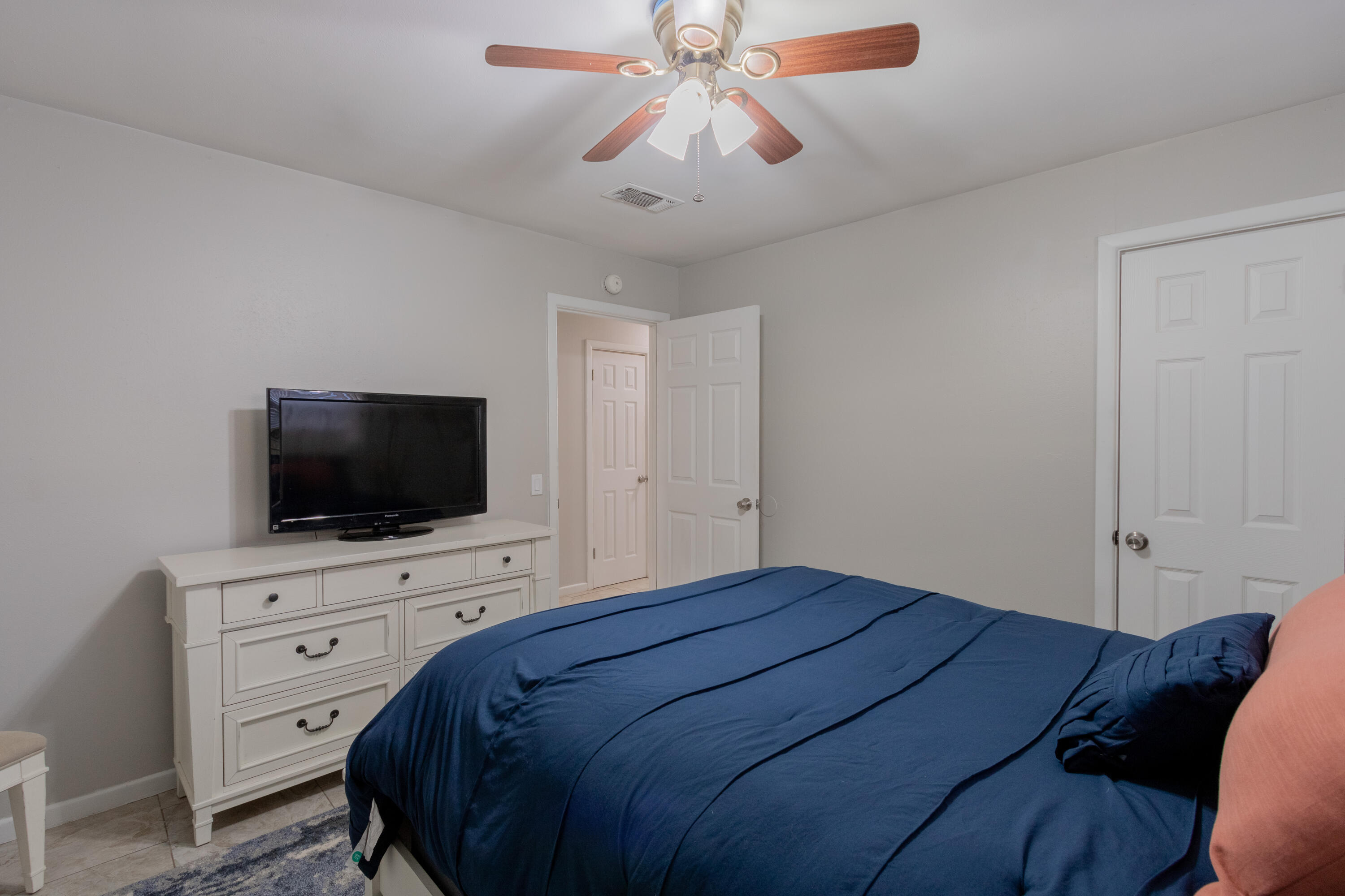 4404 49th Street Lubbock, TX 79414 - Photo 12 of 34 a bedroom with a bed and a flat screen tv
