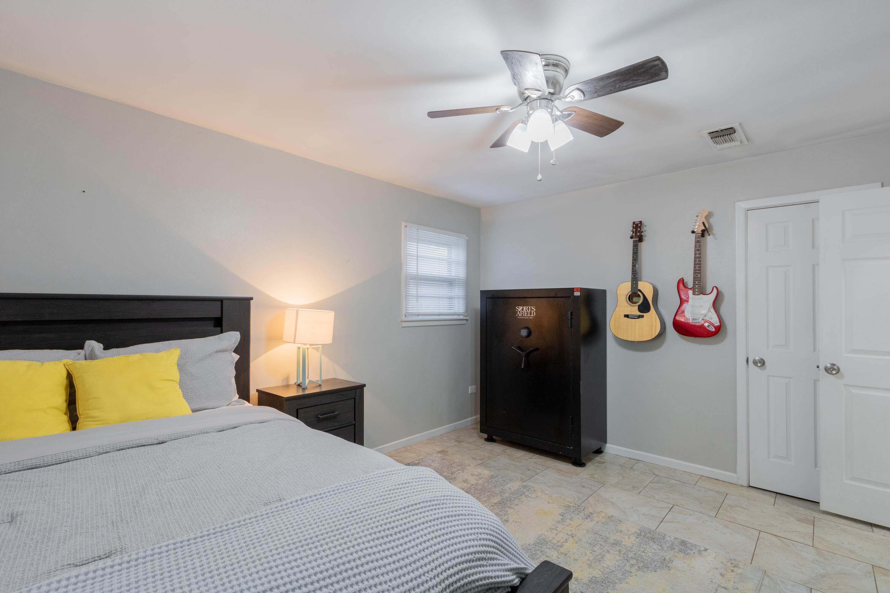 4404 49th Street Lubbock, TX 79414 - Photo 14 of 34 a bedroom with a bed and cabinets