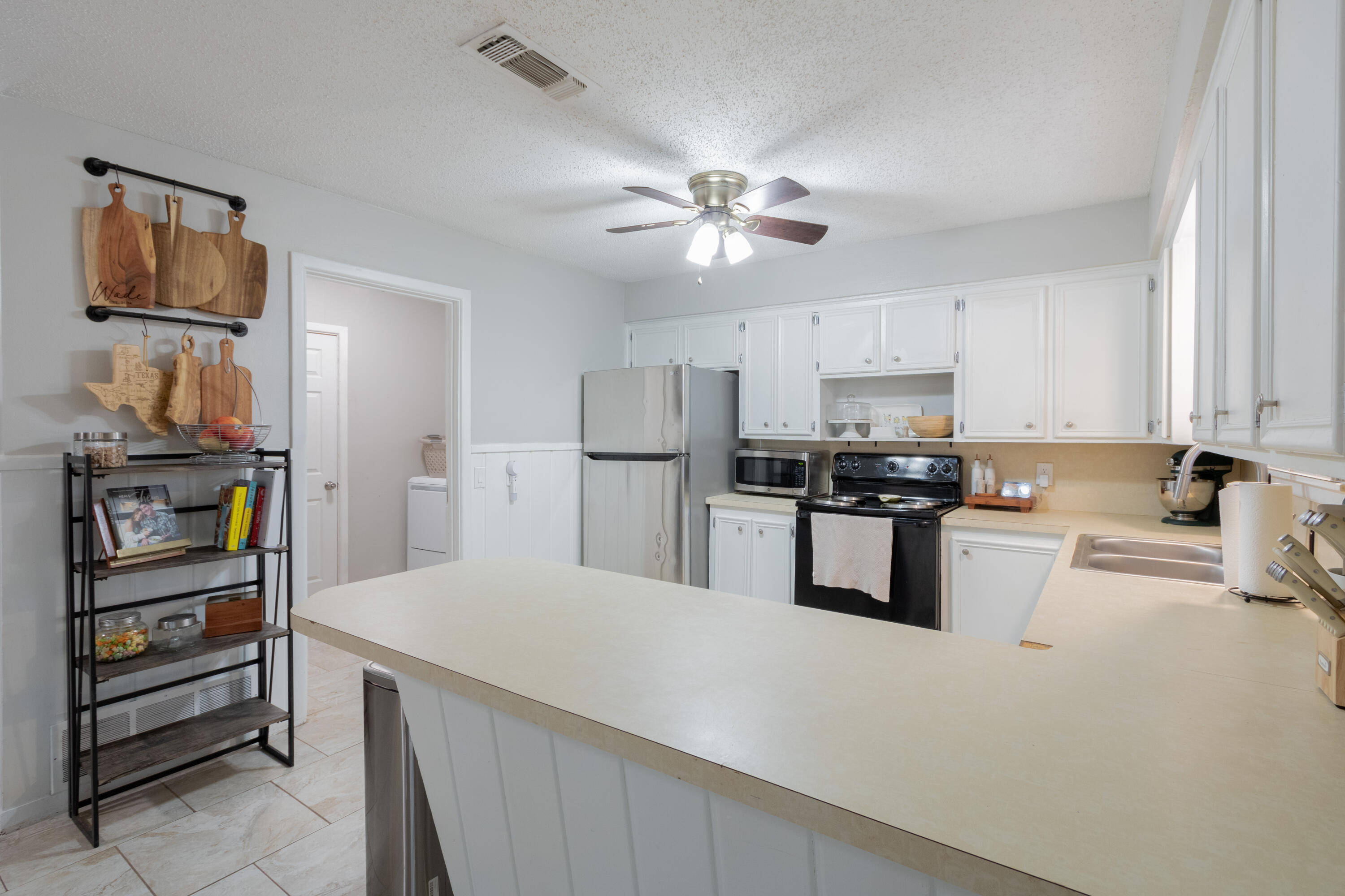 4404 49th Street Lubbock, TX 79414 - Photo 24 of 34 a kitchen with stainless steel appliances granite countertop a refrigerator and a stove top oven