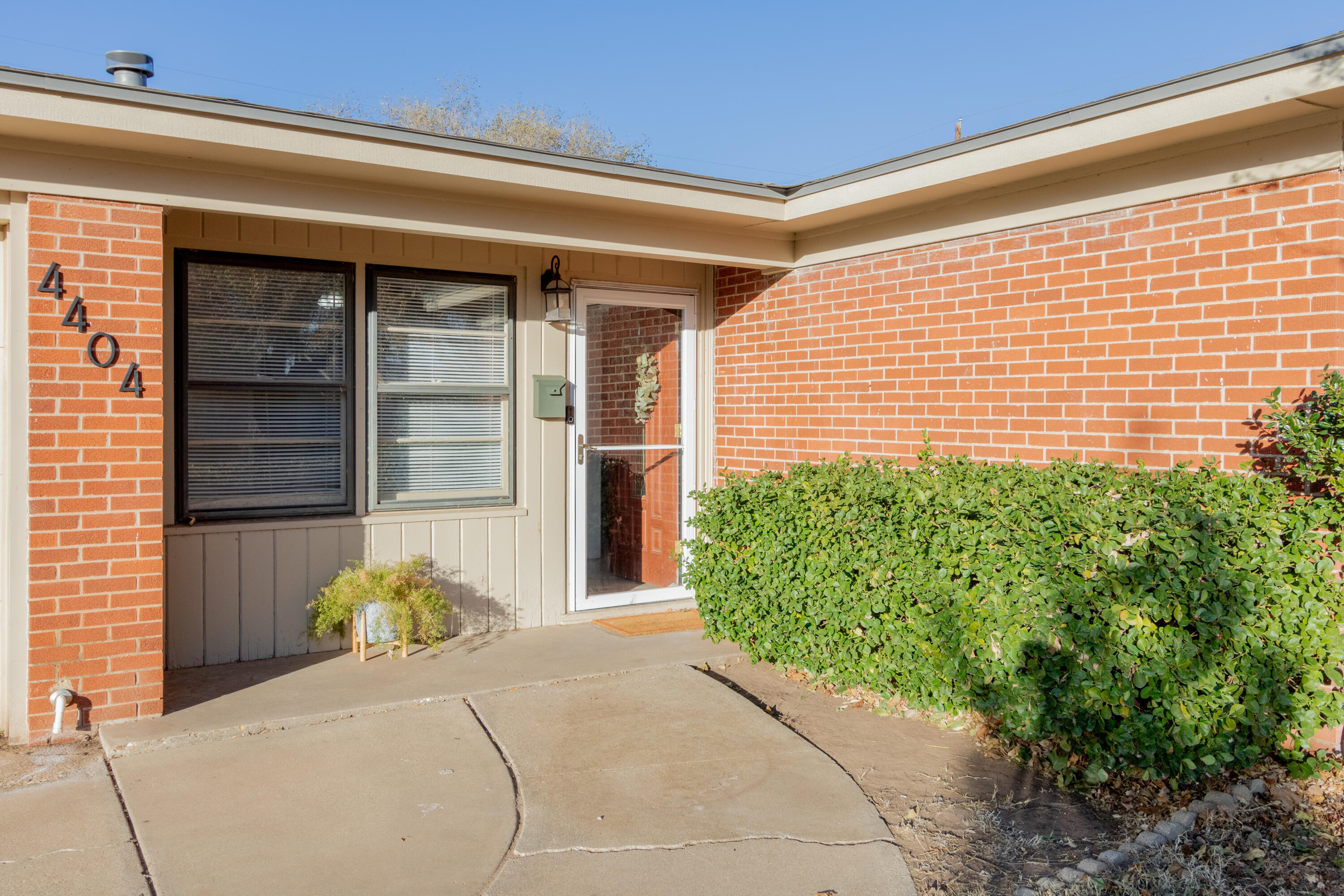 4404 49th Street Lubbock, TX 79414 - Photo 4 of 34 a front view of a house with a yard