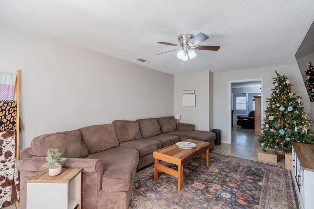 a living room with furniture a window and a chandelier