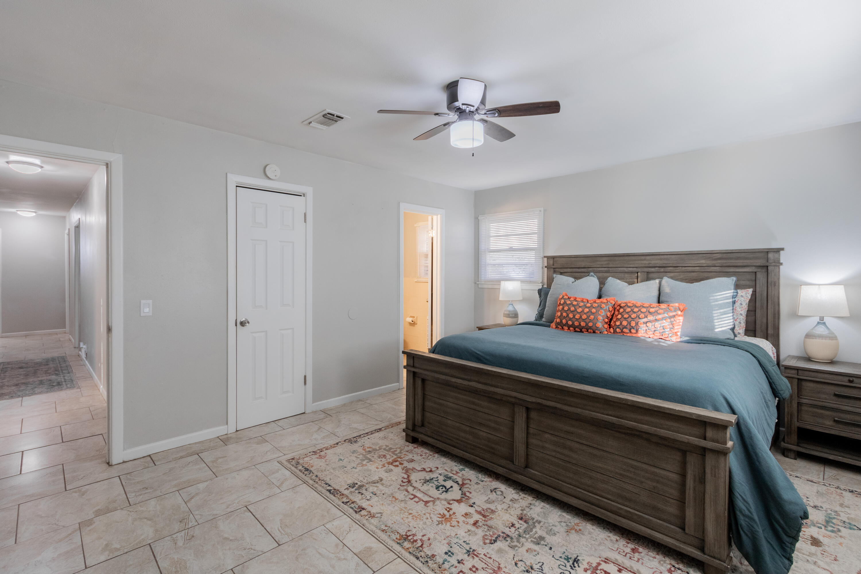 4404 49th Street Lubbock, TX 79414 - Photo 9 of 34 a bedroom with a bed and a chandelier fan