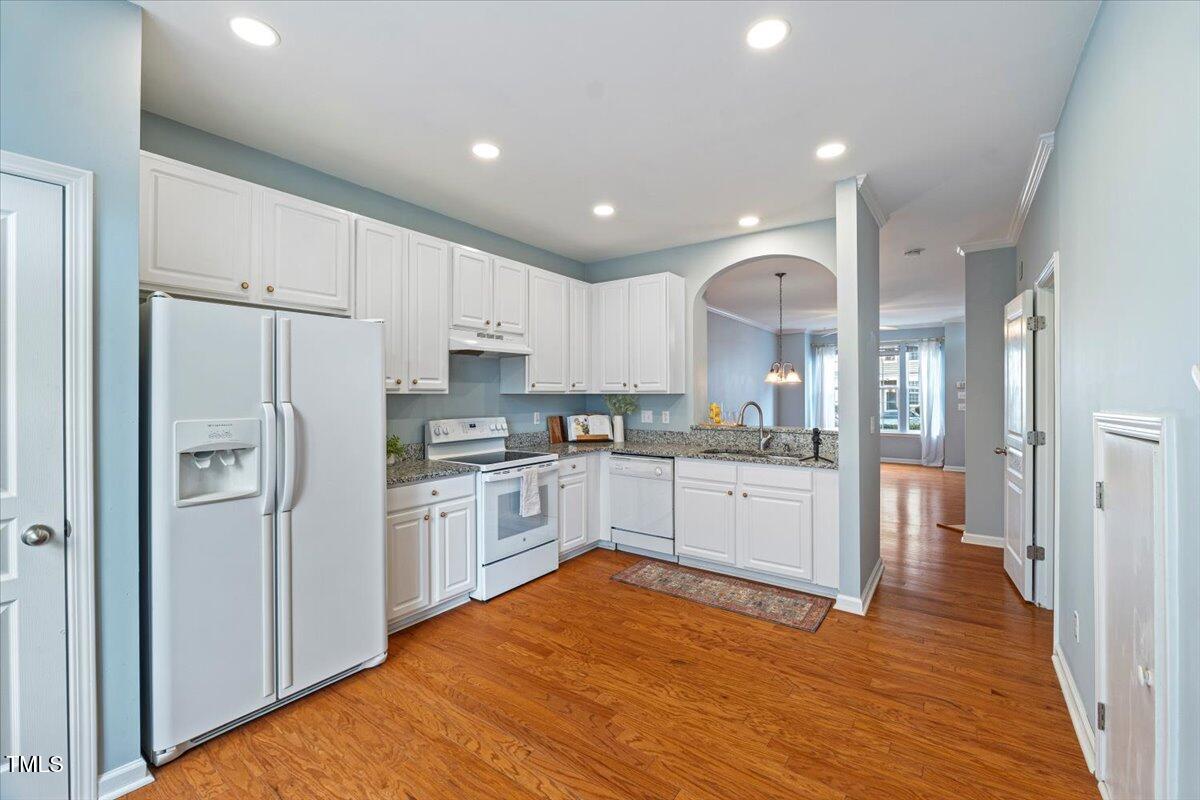 4533 Sugarbend Way Raleigh, NC 27606 - Photo 14 of 37 a kitchen with stainless steel appliances granite countertop a refrigerator and a stove top oven
