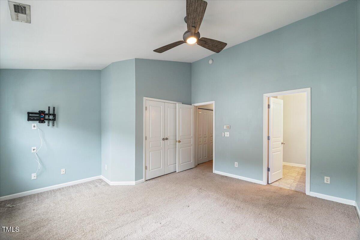 4533 Sugarbend Way Raleigh, NC 27606 - Photo 19 of 37 an empty room with a chandelier fan