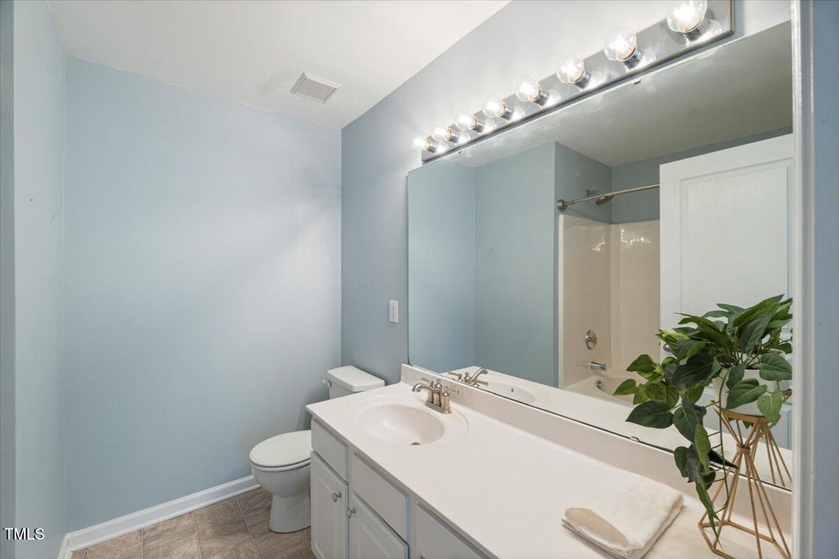 4533 Sugarbend Way Raleigh, NC 27606 - Photo 20 of 37 a bathroom with a sink and mirror with toilet