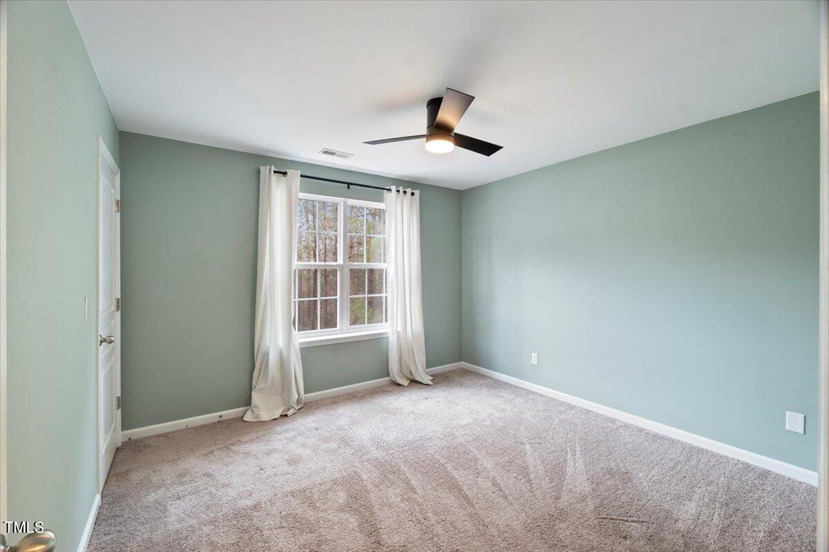 4533 Sugarbend Way Raleigh, NC 27606 - Photo 22 of 37 a view of an empty room with a window