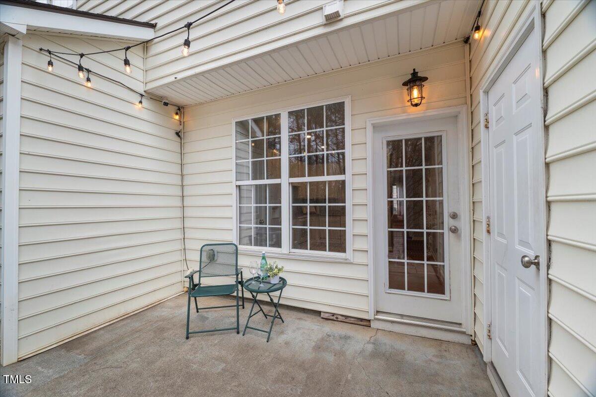 4533 Sugarbend Way Raleigh, NC 27606 - Photo 27 of 37 a view of a chair and table in the back yard of the house