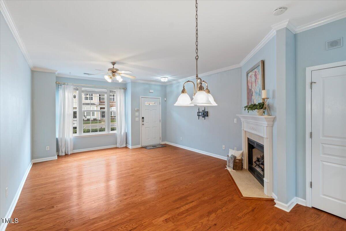 4533 Sugarbend Way Raleigh, NC 27606 - Photo 6 of 37 a view of livingroom with kitchen and fireplace