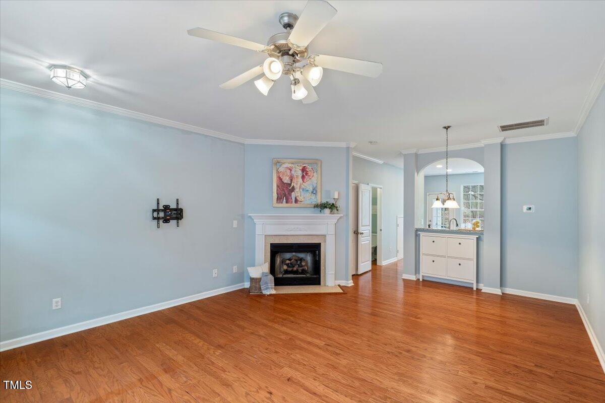 4533 Sugarbend Way Raleigh, NC 27606 - Photo 7 of 37 a view of an empty room with a fireplace and chandelier fan