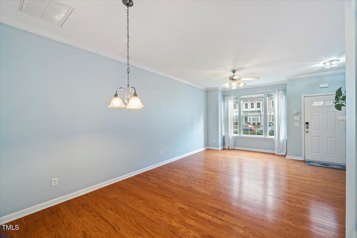4533 Sugarbend Way Raleigh, NC 27606 - Photo 9 of 37 a view of an empty room with window and wooden floor