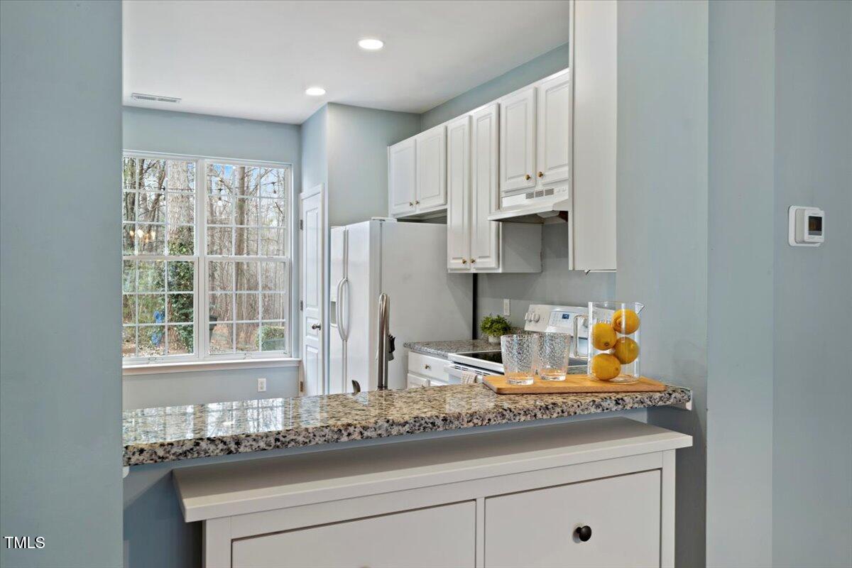 4533 Sugarbend Way Raleigh, NC 27606 - Photo 10 of 37 a kitchen with stainless steel appliances granite countertop a sink and a window